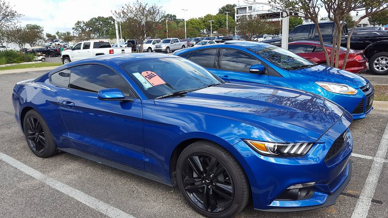 My former Focus is hiding behind the beast that is the new Mustang...